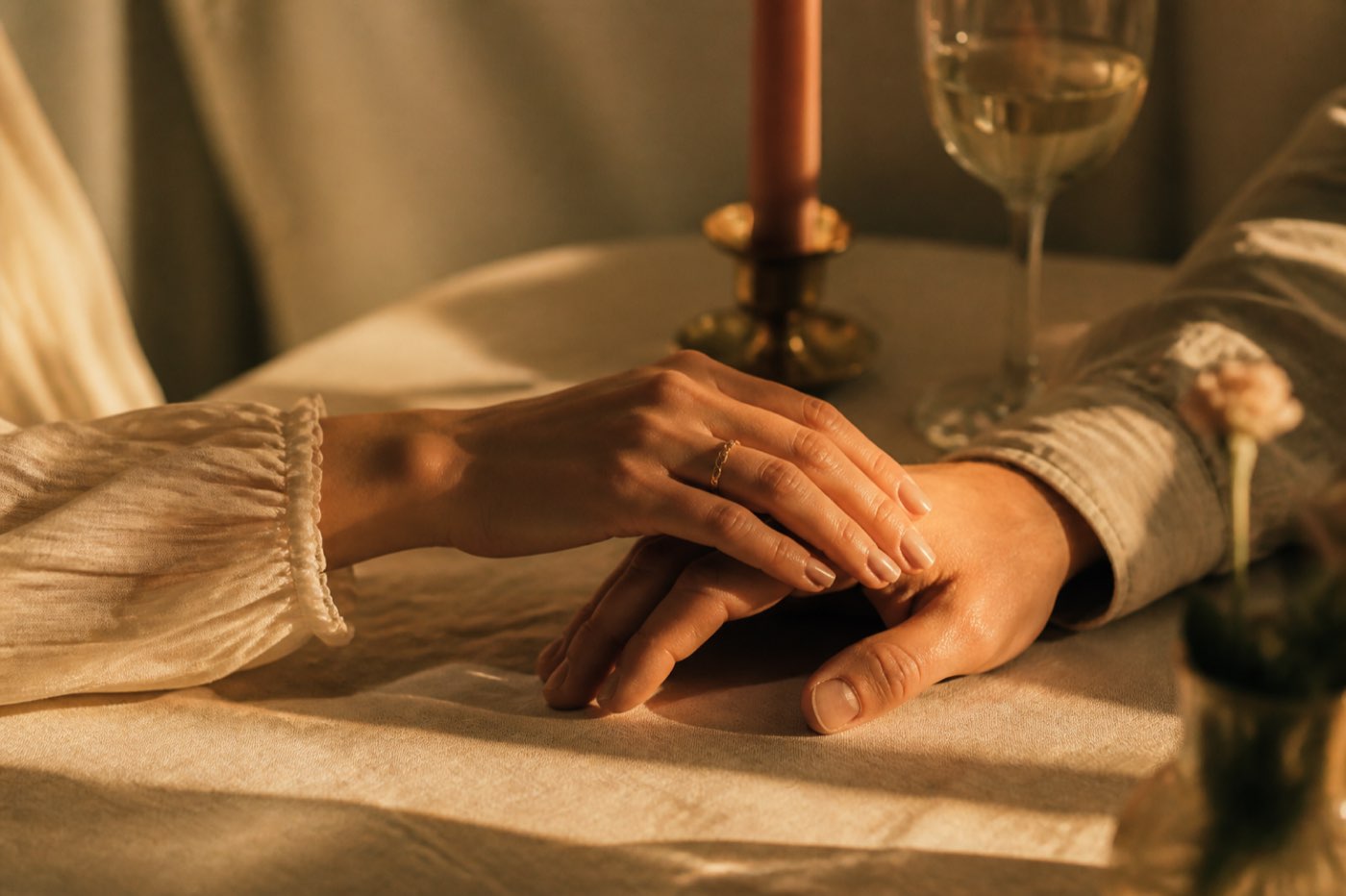 Two hands touching in warm evening light